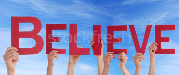 Hands Holding Believe in Red Stock photo © Nelosa
