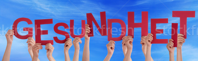 People Holding German Word Gesundheit Means Health Blue Sky Stock photo © Nelosa