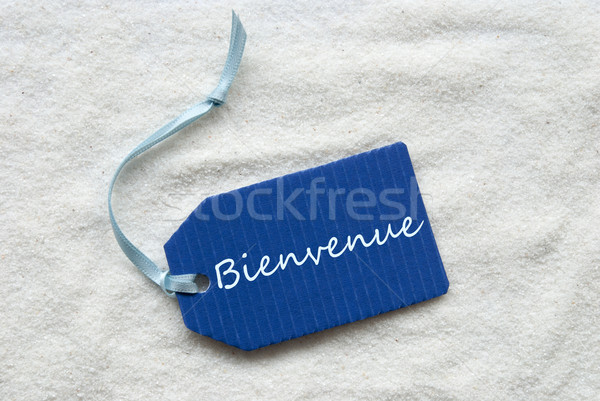 Bienvenue Means Welcome On Blue Label Sand Background Stock photo © Nelosa