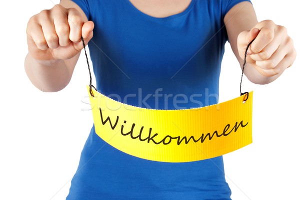 hands holding tag WIllkommen Stock photo © Nelosa