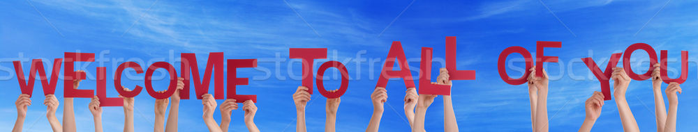 Stock photo: Many People Hands Holding Word Welcome To All Of You, Blue Sky