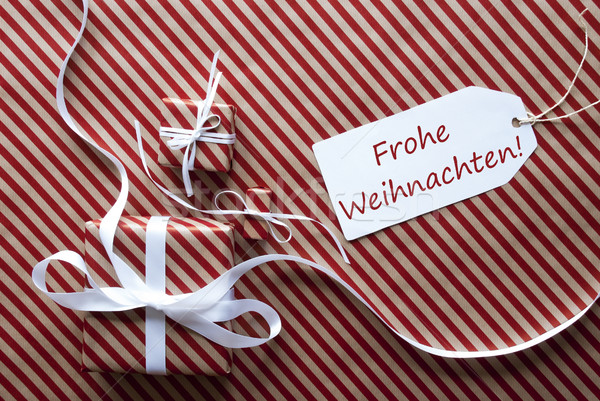 Two Gifts With Label, Frohe Weihnachten Means Merry Christmas Stock photo © Nelosa