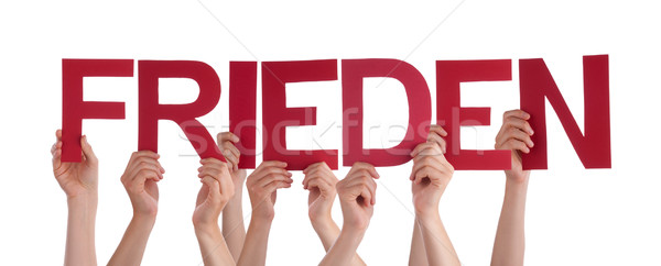 People Holding Straight German Word Frieden Means Peace Stock photo © Nelosa