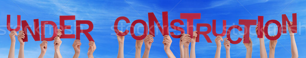 Many People Hands Holding Red Word Under Construction Blue Sky Stock photo © Nelosa