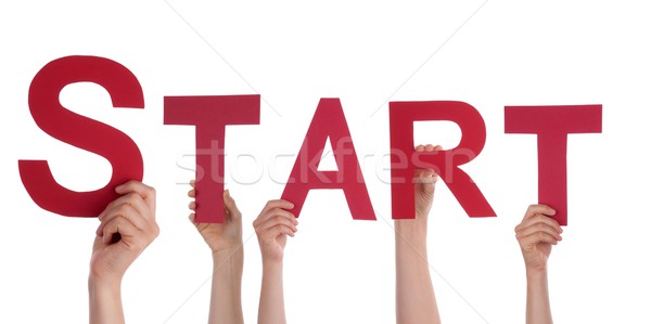 Stock photo: Hands Holding a Red Start