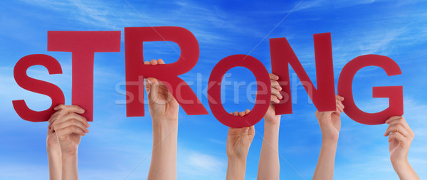 Stock photo: Many People Hands Holding Red Word Strong Blue Sky