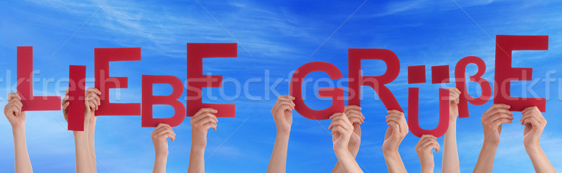 People Holding German Word Liebe Gruesse Means Love Blue Sky Stock photo © Nelosa