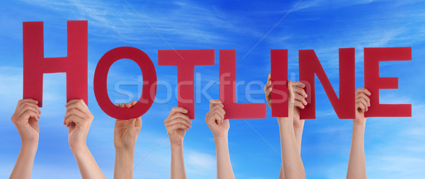 Stock photo: Many People Hands Holding Red Straight Word Hotline Blue Sky