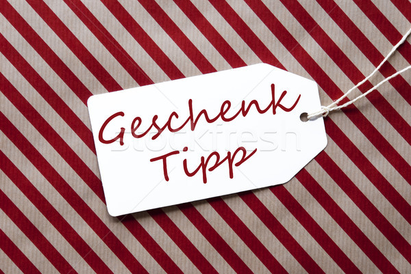 Label On Red Wrapping Paper, Geschenk Tipp Means Gift Tip Stock photo © Nelosa