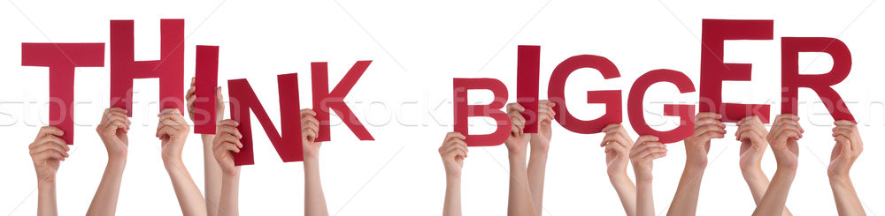 Stock photo: People Hands Holding Red Word Think Bigger 