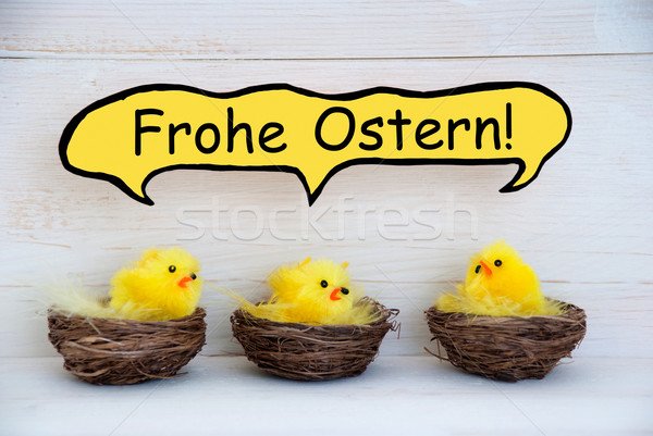 Three Chicks With Comic Speech Balloon German Frohe Ostern Means Happy Easter Stock photo © Nelosa