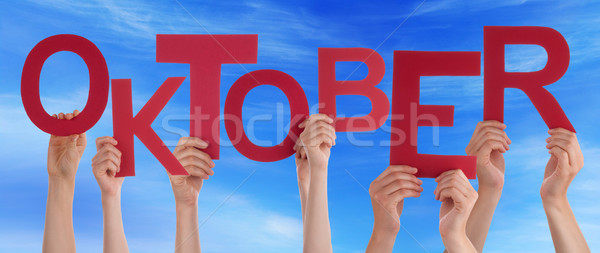 People Holding Word Oktober Means October Blue Sky Stock photo © Nelosa