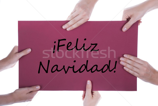 Hands Holding Sign with Feliz Navidad Stock photo © Nelosa
