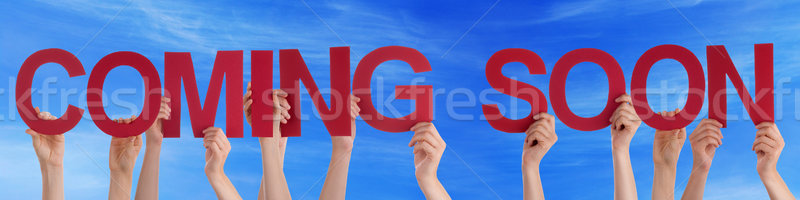 People Hands Holding Red Straight Word Coming Soon Blue Sky Stock photo © Nelosa