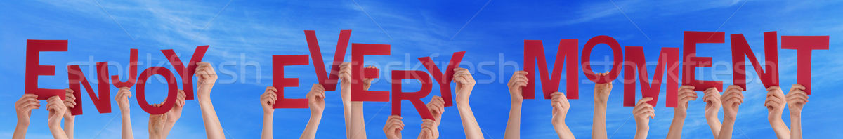 People Hands Holding Red Word Enjoy Every Moment Blue Sky Stock photo © Nelosa