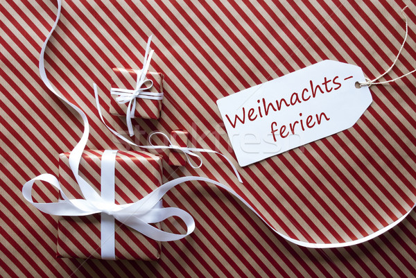 Two Gifts With Label, Weihnachtsferien Means Christmas Break Stock photo © Nelosa