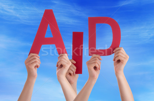 Many People Hands Holding Red Word Aid Blue Sky Stock photo © Nelosa