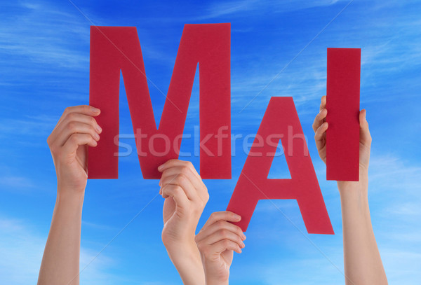People Holding German Word Mai Means May Blue Sky Stock photo © Nelosa