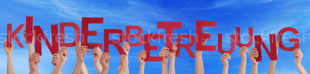 People Holding German Word Kinderbetreuung Means Child Care Blue Stock photo © Nelosa