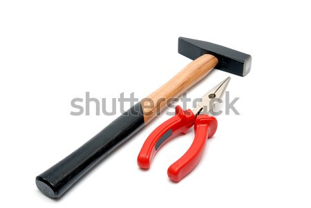 Stock photo: Hammer and flat-nose pliers with red handles isolated over white background