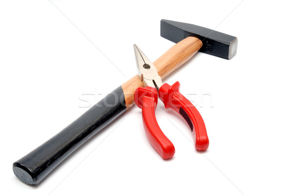 Hammer and flat-nose pliers with red handles isolated over white background Stock photo © nemalo