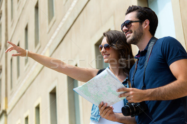 Young tourist couple use their map and pointing where they want  Stock photo © nenetus