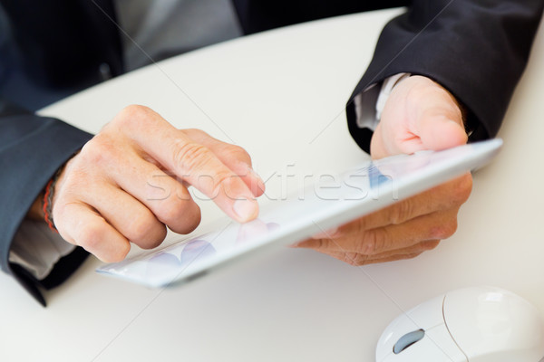 Businessman finger pointing to the screen of a digital tablet. Stock photo © nenetus