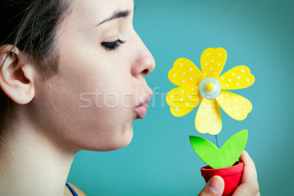 Beautiful young woman blowing on artificial daisy Stock photo © nenetus