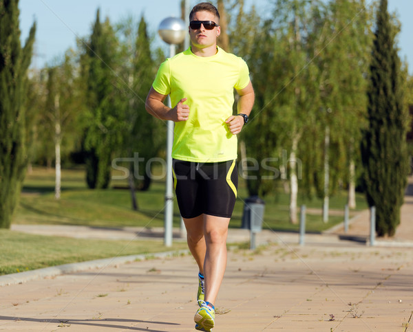 Handsome young man running in the park. Stock photo © nenetus