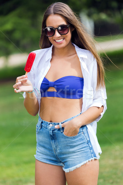 Happy Young girl in bikini, eating an strawberry ice cream, outd Stock photo © nenetus