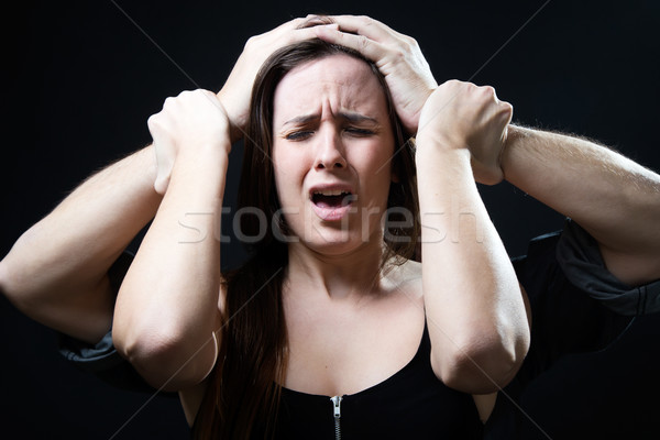 Young woman with a male hands pressing her head. Concept of oppr Stock photo © nenetus
