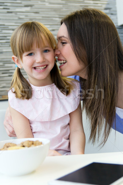 mother giving a kiss to his daughter on the cheek Stock photo © nenetus