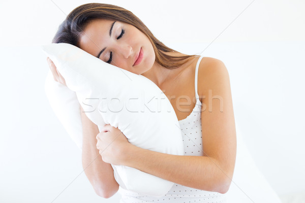 Gyönyörű fiatal nő tart párna ágy portré Stock fotó © nenetus