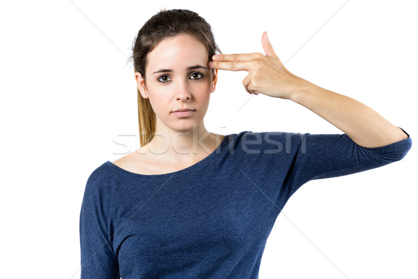 Young woman simulates to shoot himself in the head with one hand Stock photo © nenetus