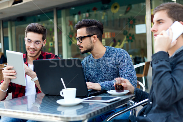 Outdoor portrait of young entrepreneurs working at coffee bar. Stock photo © nenetus