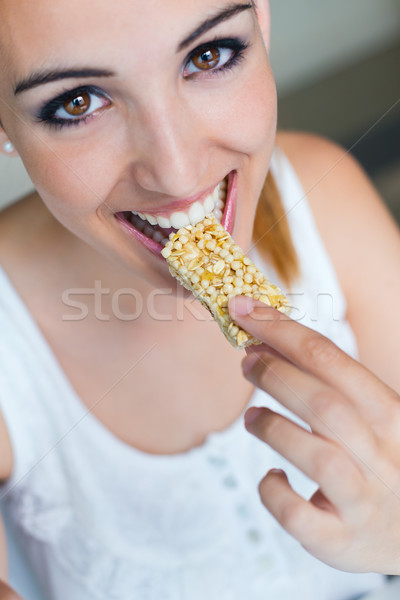 Woman eating muesli bar snack.  Stock photo © nenetus