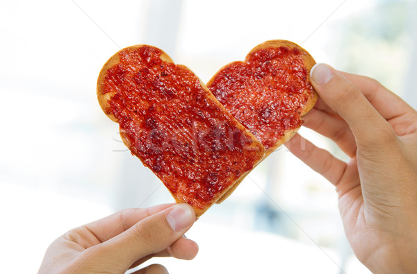 Couple making heart sign with two slices of bread with jam Stock photo © nenetus