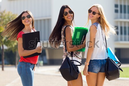Three students girls walking in the campus of university. Stock photo © nenetus