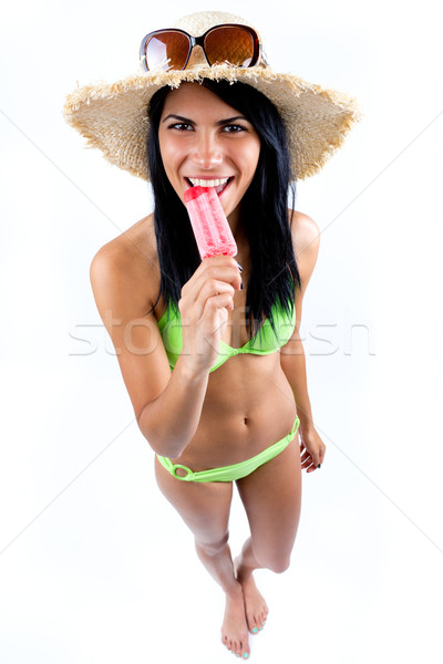 Stock photo: Happy Young girl in bikini, eating an strawberry ice cream