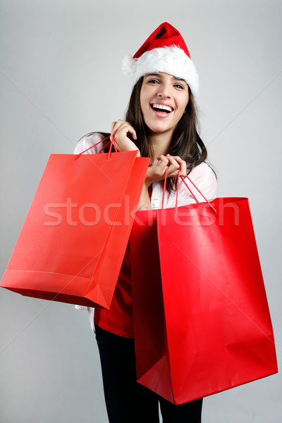 Beautiful santa girl  carrying red shopping bags Stock photo © nenetus