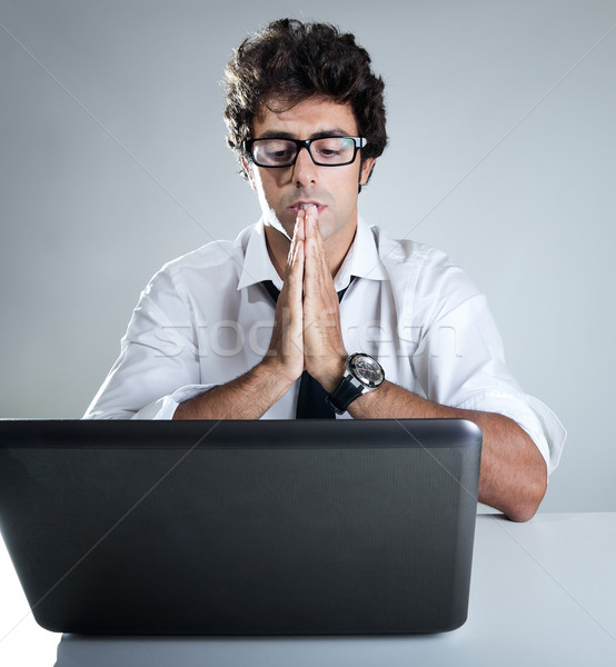 Stock photo: Executive thinking in front of his laptop