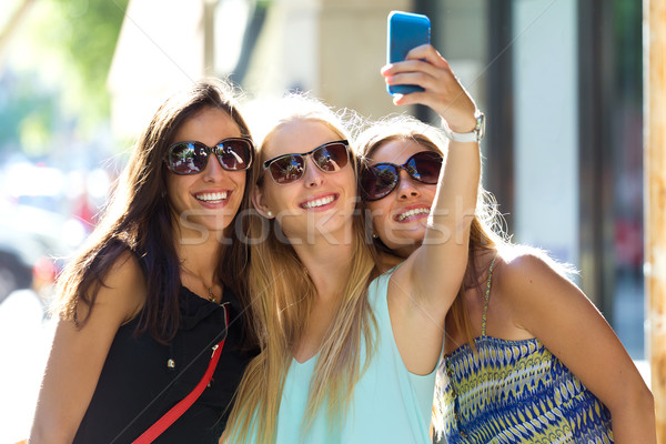 Group of friends taking selfie in the street.  Stock photo © nenetus