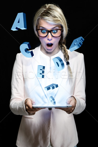 Surprised young teacher woman looking a digital tablet. Educatio Stock photo © nenetus