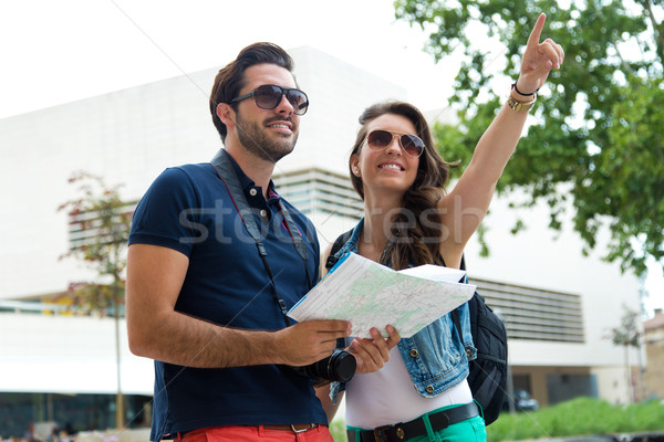 Young tourist couple use their map and pointing where they want  Stock photo © nenetus