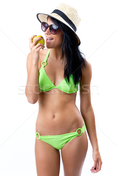 Happy Young girl in bikini, eating an apple Stock photo © nenetus