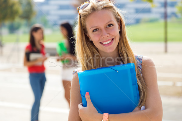 Pretty student girl with some friends at the campus Stock photo © nenetus