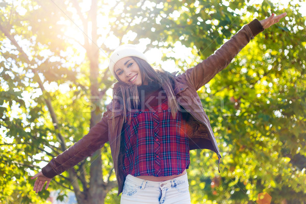 Portrait of beautiful girl standing in autumn field with arms ra Stock photo © nenetus