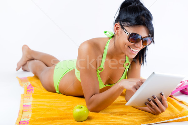Happy young girl with green bikini and digital table Stock photo © nenetus