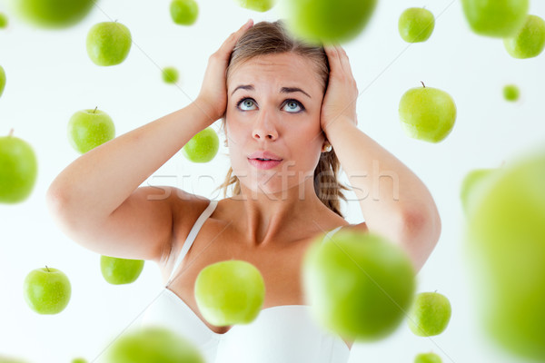 Young girl overwhelmed by diet, surrounded by apples. Stock photo © nenetus