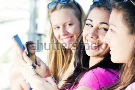 Três meninas smartphones parque mulheres Foto stock © nenetus